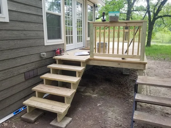 Outdoor patio stone paving and deck transition