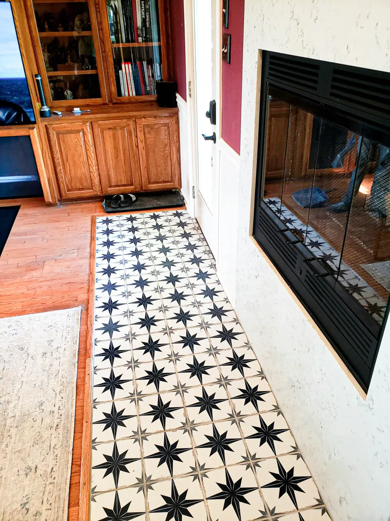 Finished hardwood flooring around fireplace stone hearth