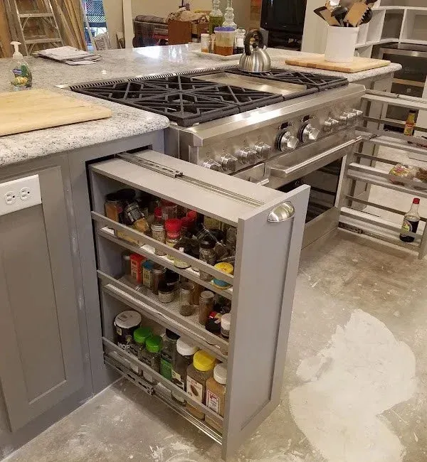 Spacious custom pantry featuring built-in wooden shelving and a dedicated wine refrigerator