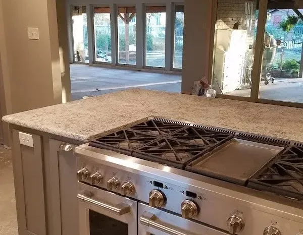 Sparkling clean farmhouse kitchen sink and faucet