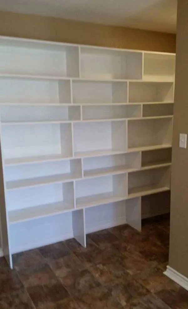 Finished fireplace custom built-in shelving and cabinets next to the fireplace