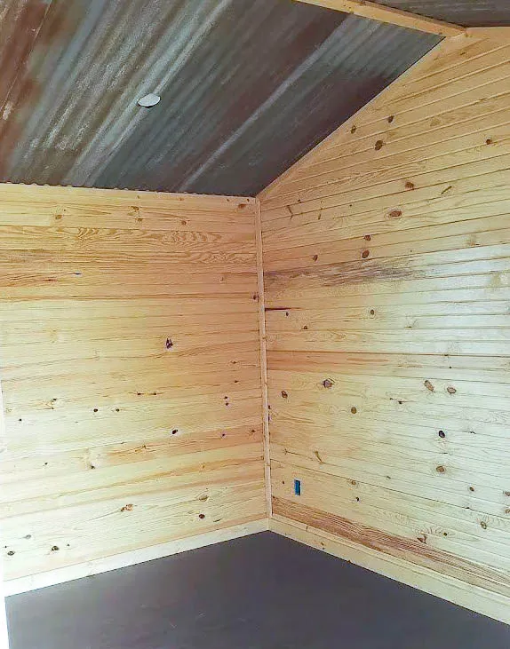 Finished exposed box beams in vaulted living room ceiling
