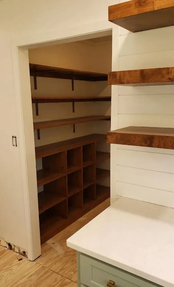 Clean white painted shelving units installed in home office alcove